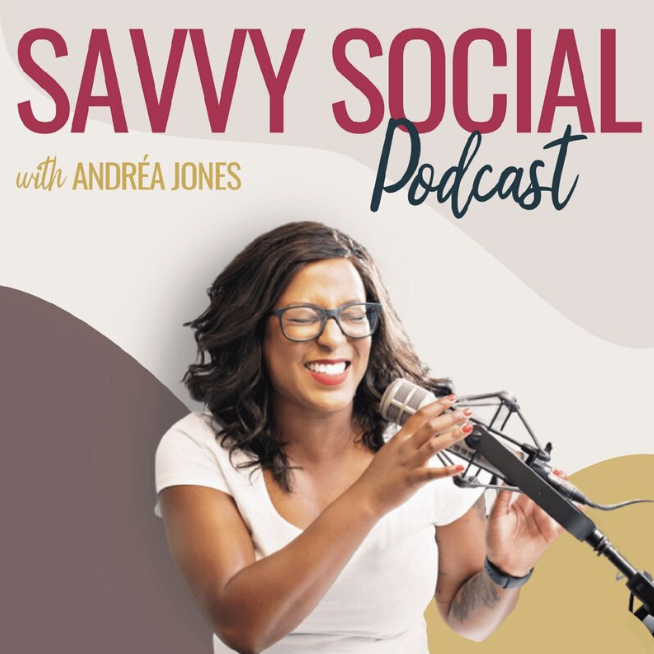 This image features a promotional graphic for the "SAVVY SOCIAL Podcast with ANDRÉA JONES". The graphic showcases a cheerful woman with dark hair wearing glasses and a white top, holding a microphone with her right hand and seemingly laughing or speaking animatedly. The text is divided with "SAVVY SOCIAL" in large, bold maroon letters and "Podcast" in a cursive, dark grey font. "with ANDRÉA JONES" is written in smaller, uppercase letters below. The background is a soft blend of neutral tones with a circular overlay, giving a warm and approachable feel to the design.